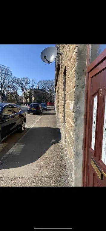 a building with a light on the side of a street at NC500, Wick Caithness Holiday Home in Wick