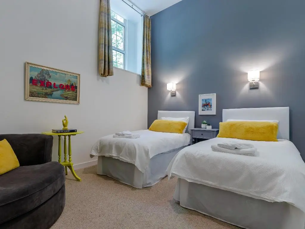 a room with two beds and a couch in it at Torreagles in Mintlaw