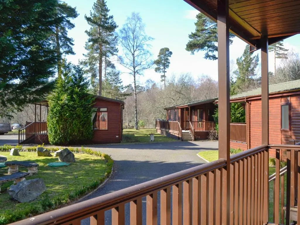 a view of a cabin from the porch of a house at Lodge D- Uk33090 in Dinnet
