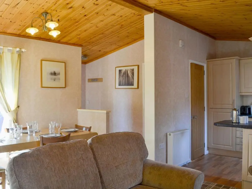 a living room with a couch and a table at Lodge A- Uk33088 in Dinnet