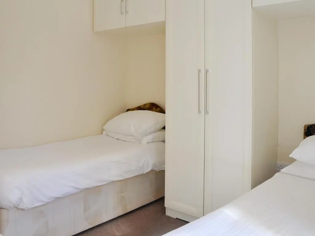 a small bedroom with two beds and a closet at Lodge F- Uk33092 in Dinnet