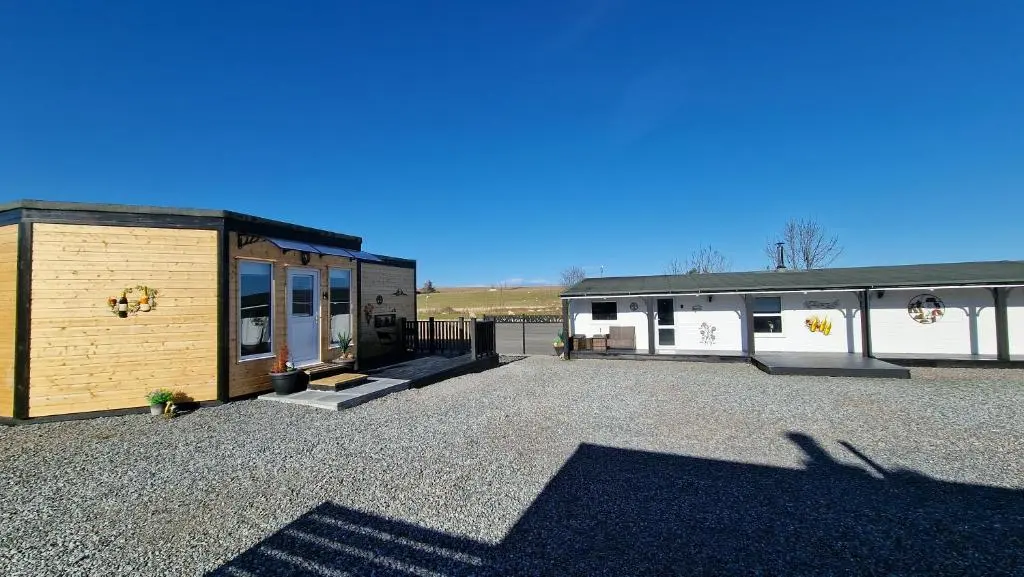 a large parking lot with a house and a building at Meadows 2 in Auldearn