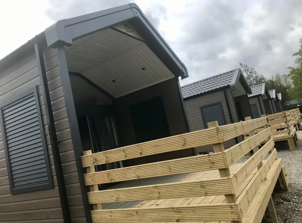 a modular home with a wooden deck in front of it at 2 Bed Self-Catering Lodge Inverness - Sleeps 4 in Inverness