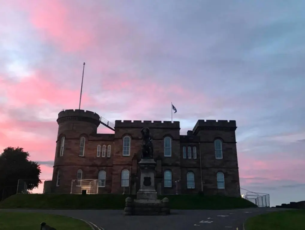 a castle with a flag on top of it at 2 Bed Self-Catering Lodge Inverness - Sleeps 4 in Inverness