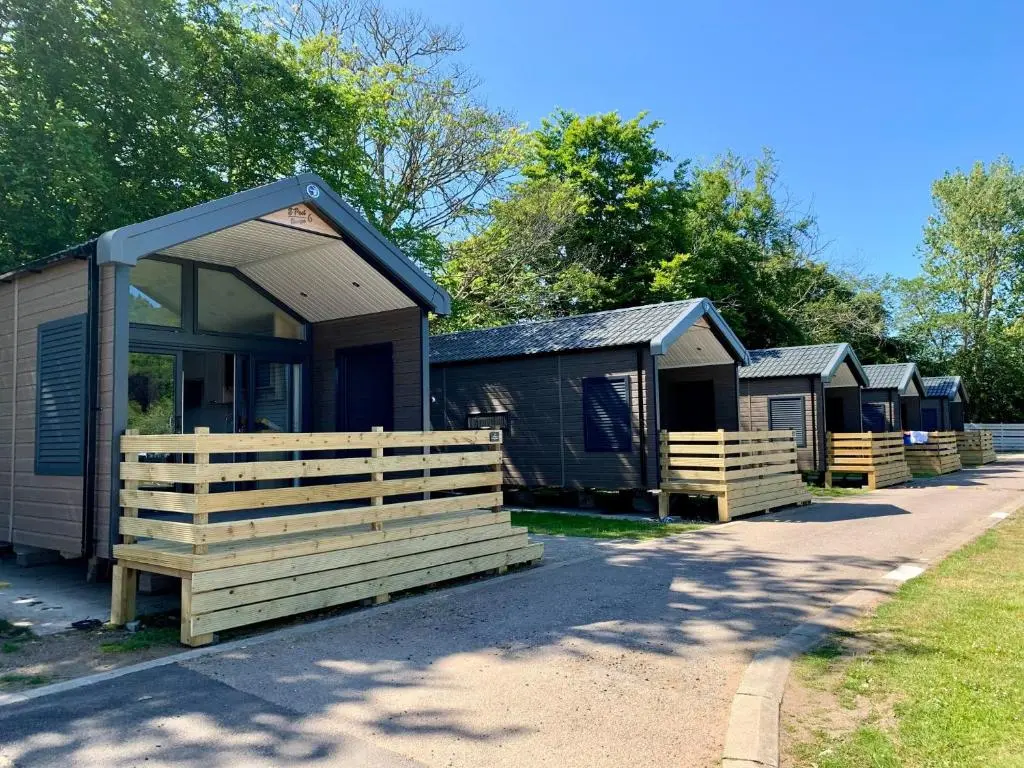 a row of camping cottages parked next to a road at 2 Bed Inverness - Sleeps 4 - Parking - Wifi in Inverness