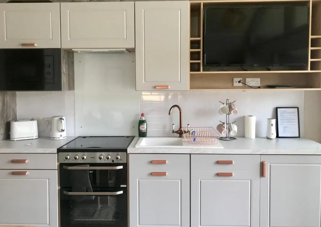 a kitchen with white cabinets and a sink at 2 Bed Lodge - Sleeps 4 - Parking - Wifi in Inverness