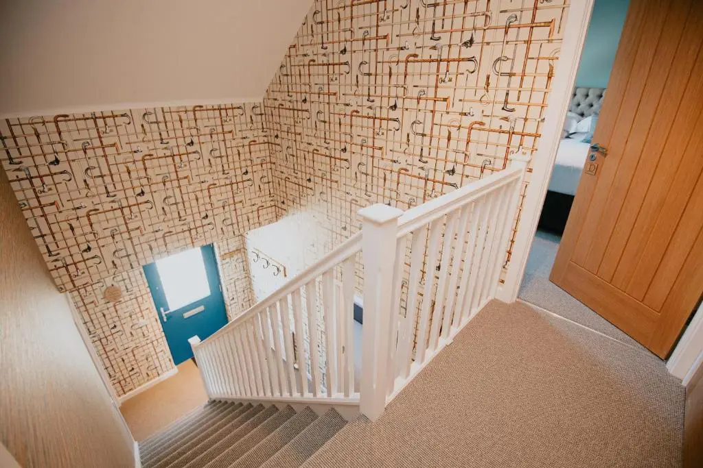 a staircase with a wall covered in writing on it at The Seafield Arms Hotel Cullen - Self Catering in Cullen