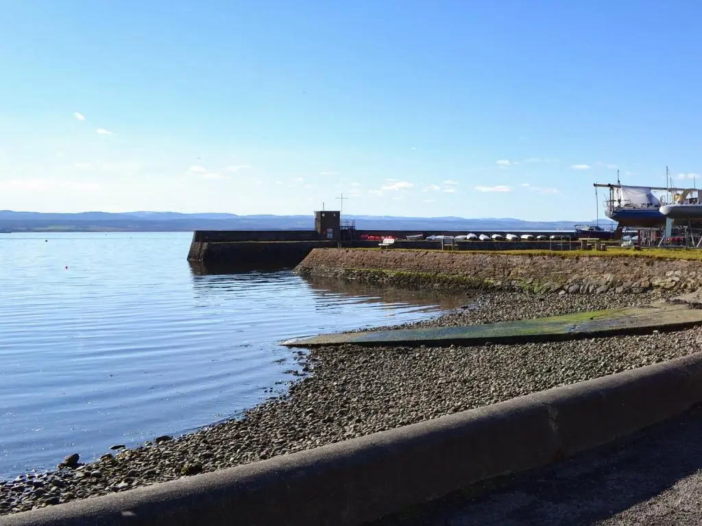 a view of a body of water with a pier at The Shore in Fortrose