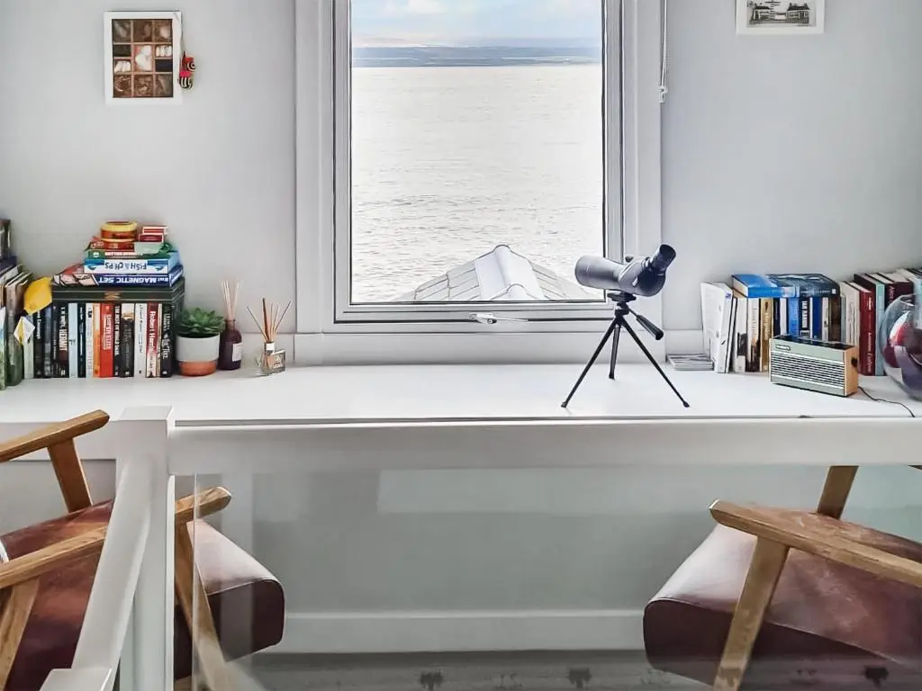 a window with a camera and a tripod on a window sill at The Shore in Fortrose