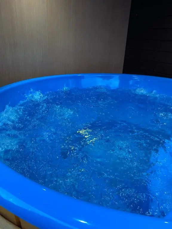 a blue bath tub filled with blue water at Lovely 1-Bed House in Fochabers Scotland in Fochabers