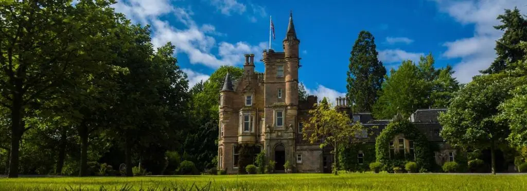 an old castle in the middle of a field at Highland Lodge in Kilmorack