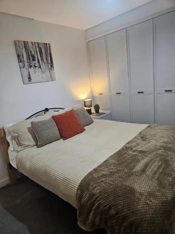 a bedroom with a large bed with pillows on it at No 14, 3 BED all with SMART TV's, Fully Fitted Kitchen, Ample PARKING, Ideal for TRADES, BUSINESS wanting comfort and a quality service REDUCTIONS FOR LONGER STAYS Langley Cottages and Apartments, in Wick