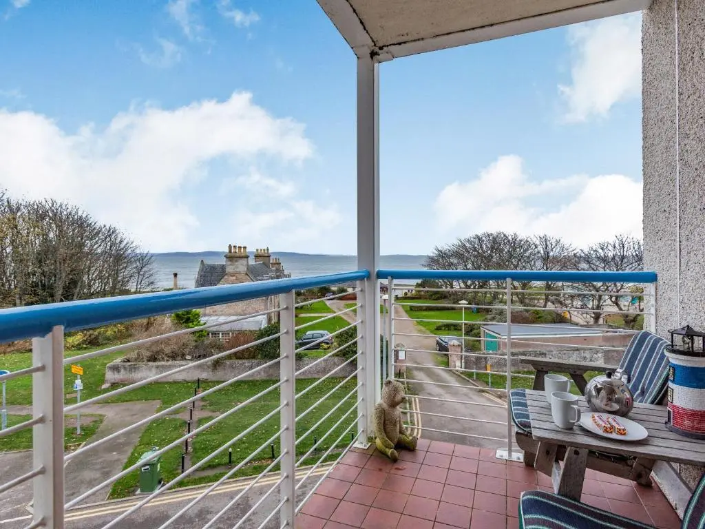 a balcony with a view of the ocean at Moray Firth View in Nairn