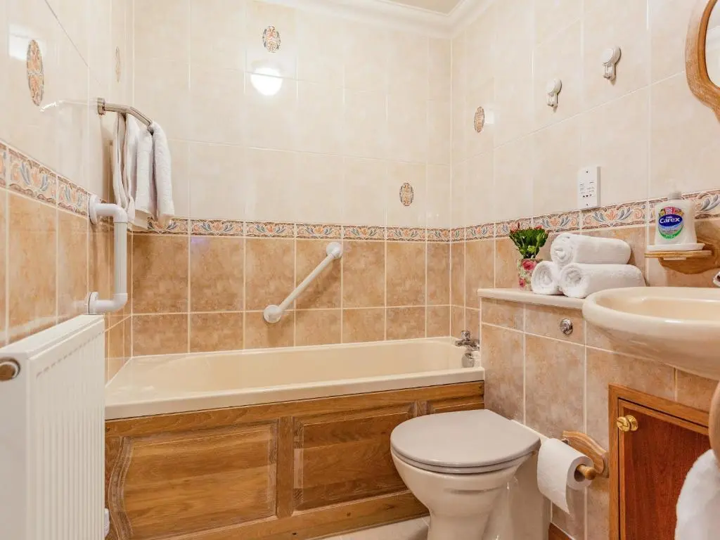 a bathroom with a tub and a toilet and a sink at Moray Firth View in Nairn