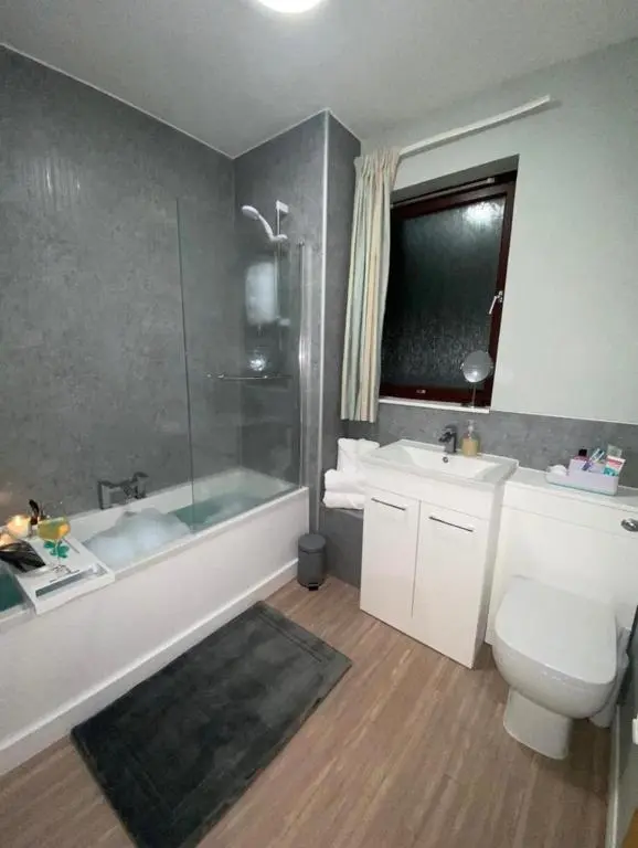 a bathroom with a tub and a toilet and a sink at Harbour and River View, Beach 50m from doorstep & free parking in Nairn