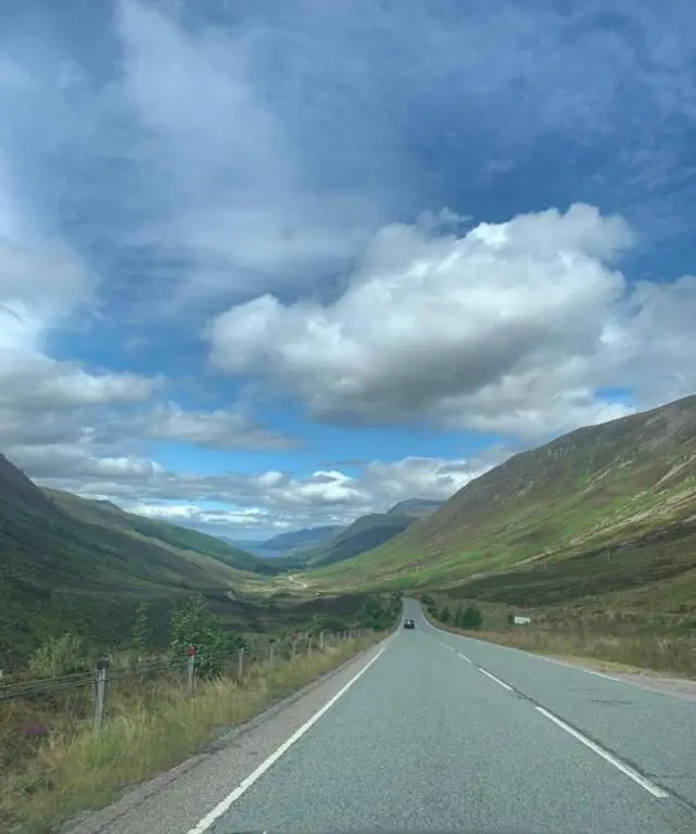 an empty road in the middle of a valley at Harbour and River View, Beach 50m from doorstep & free parking in Nairn