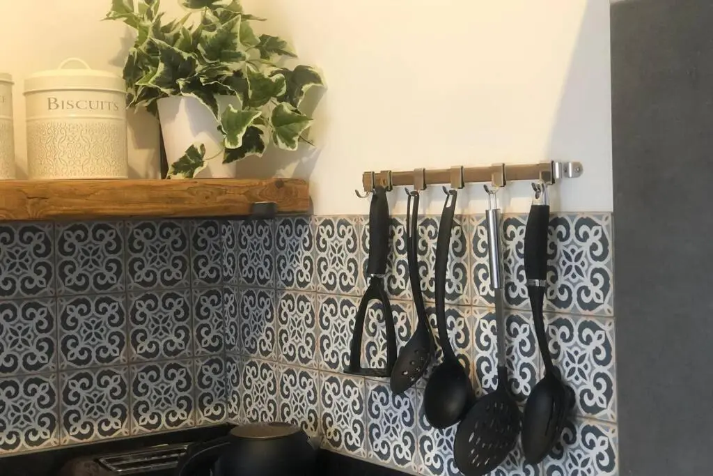 a group of utensils hanging on a kitchen wall at Seacot Cottage in the heart of the Highlands in South Kessock
