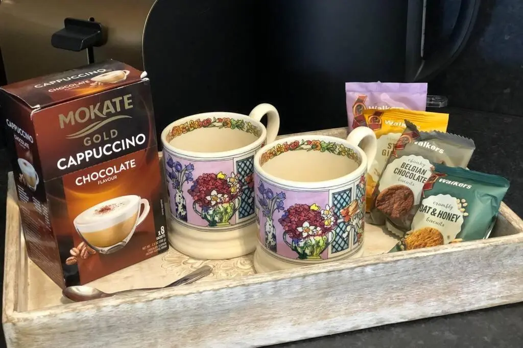 a tray with three cups of coffee and other snacks at Seacot Cottage in the heart of the Highlands in South Kessock