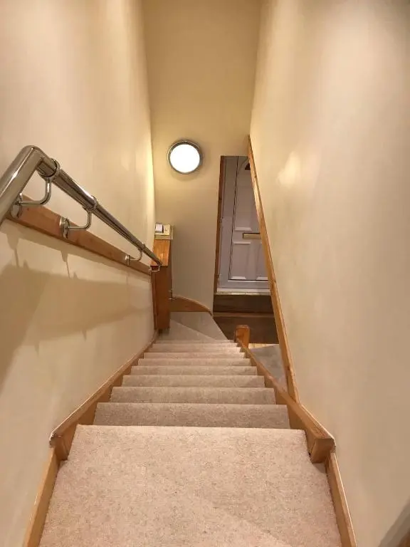 a set of stairs in a building with a door at No 10 The Cottage in Inverness