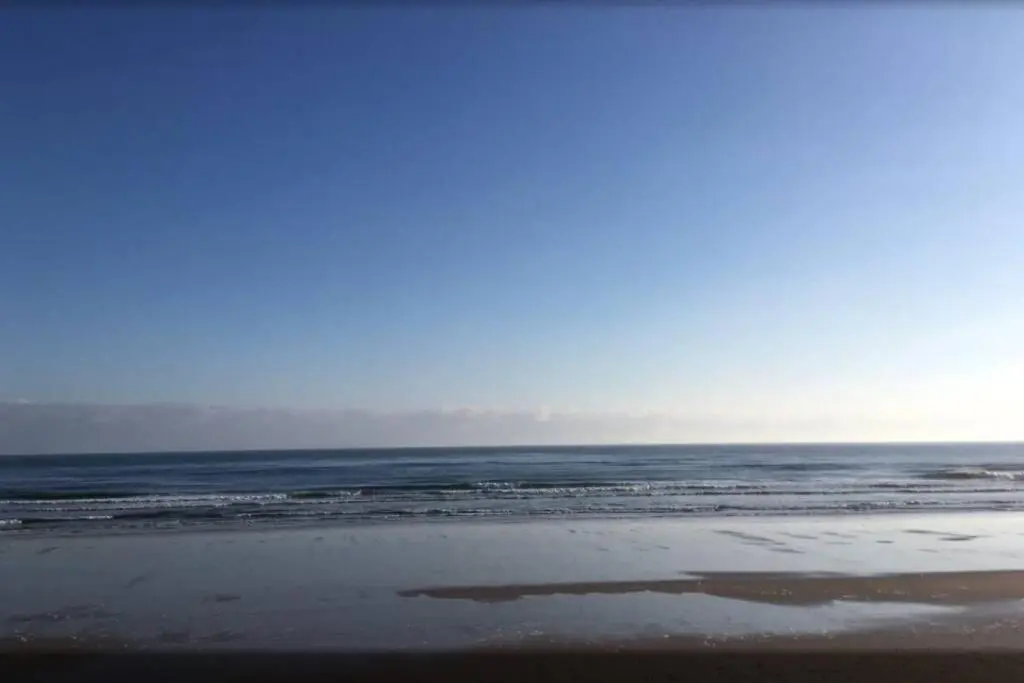 a sandy beach with the ocean in the background at Craigewan Cottage Seatown Cullen in Cullen