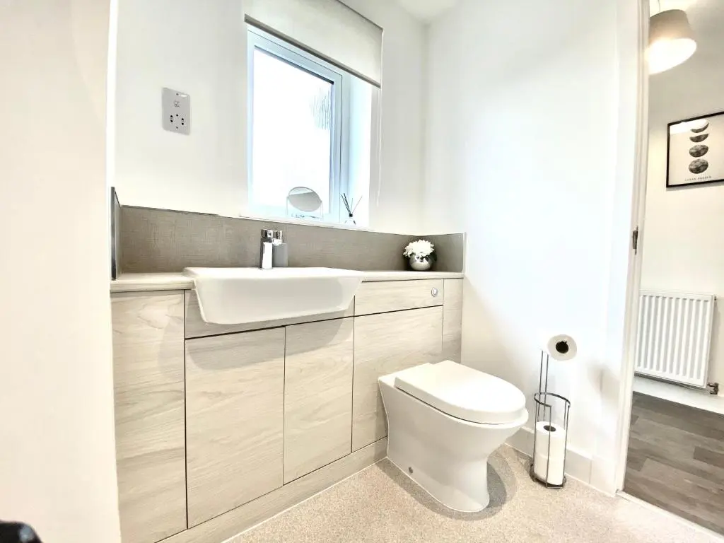 a white bathroom with a sink and a toilet at Serviced Accommodation Moray Cawdor Avenue, Elgin in Elgin