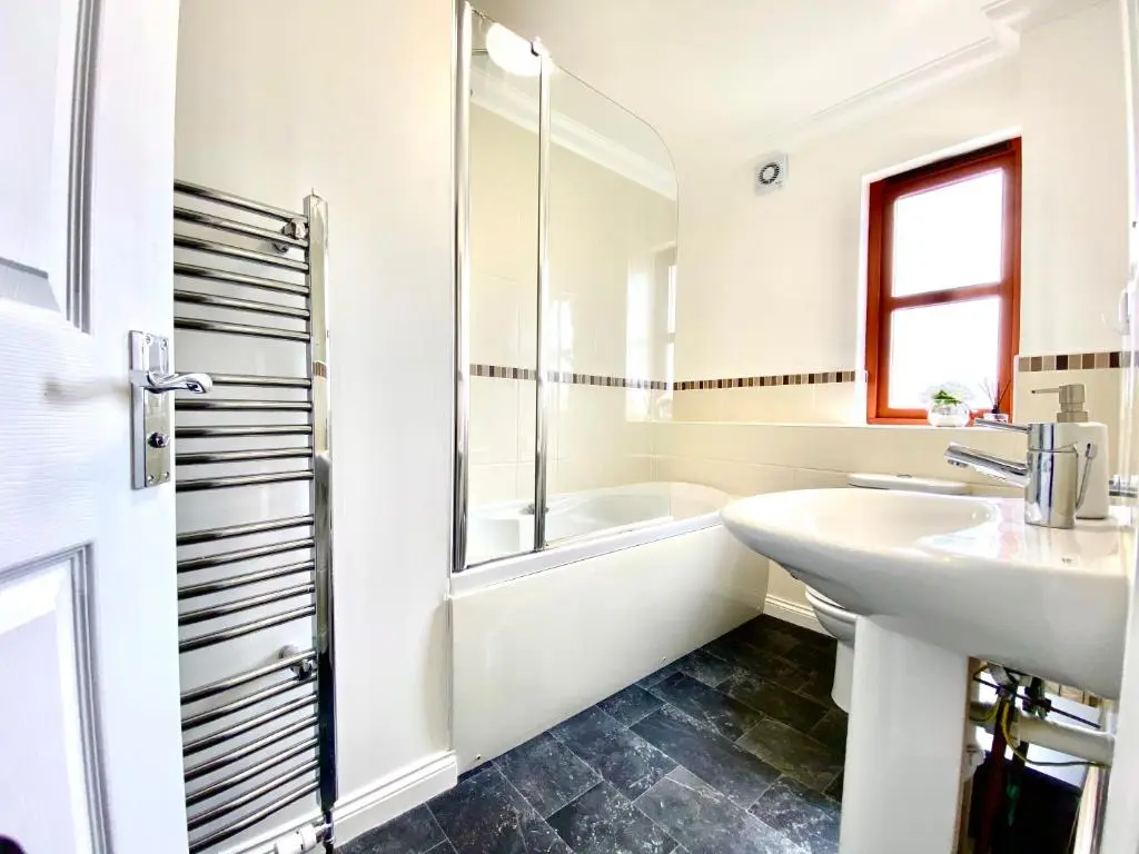 a white bathroom with a sink and a tub at 100 Thornhill Drive, Elgin in Elgin
