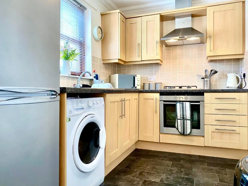 a kitchen with a washer and dryer in it at 100 Thornhill Drive, Elgin in Elgin