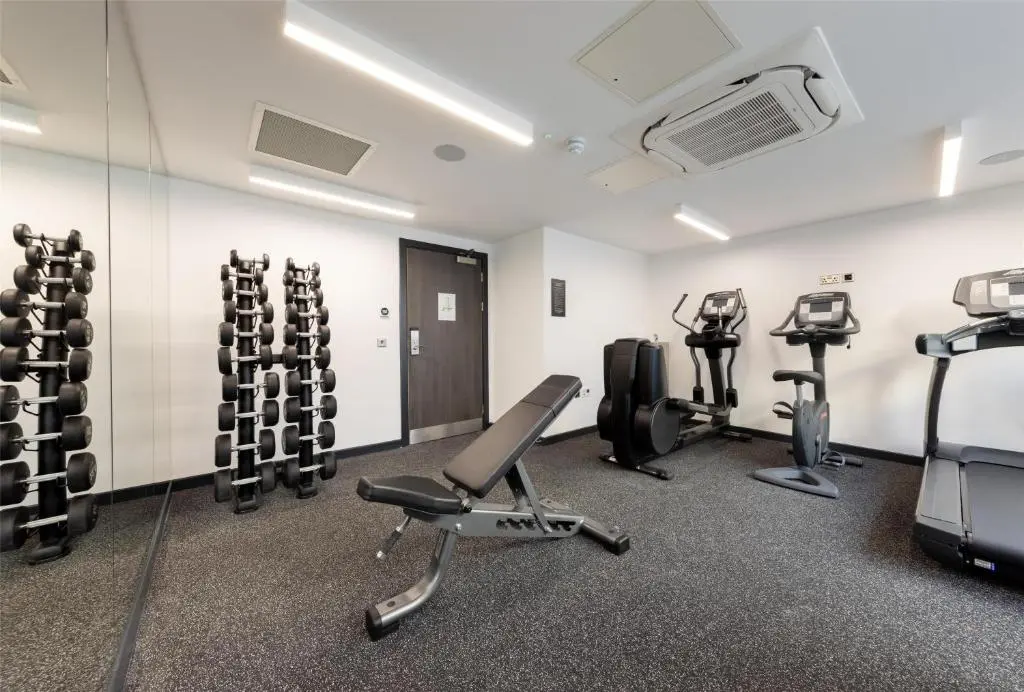 a gym with treadmills and exercise equipment in a room at River Ness Hotel, a member of Radisson Individuals in Inverness