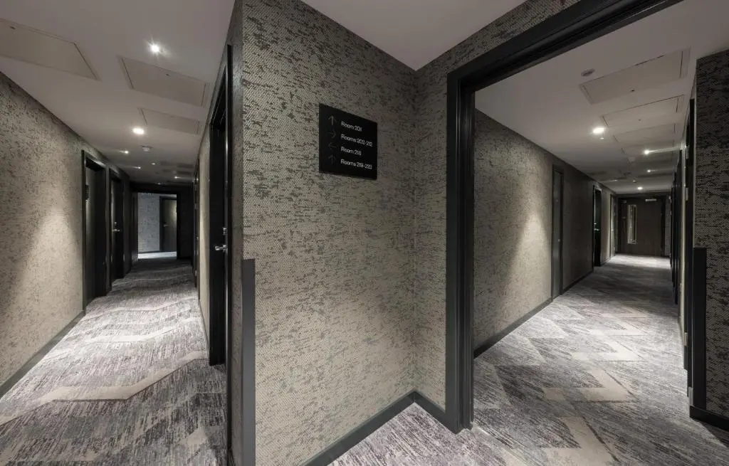 a corridor of an office with a sign on the wall at River Ness Hotel, a member of Radisson Individuals in Inverness