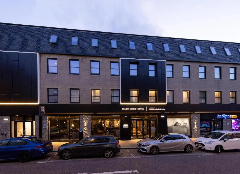 a group of cars parked in front of a building at River Ness Hotel, a member of Radisson Individuals in Inverness