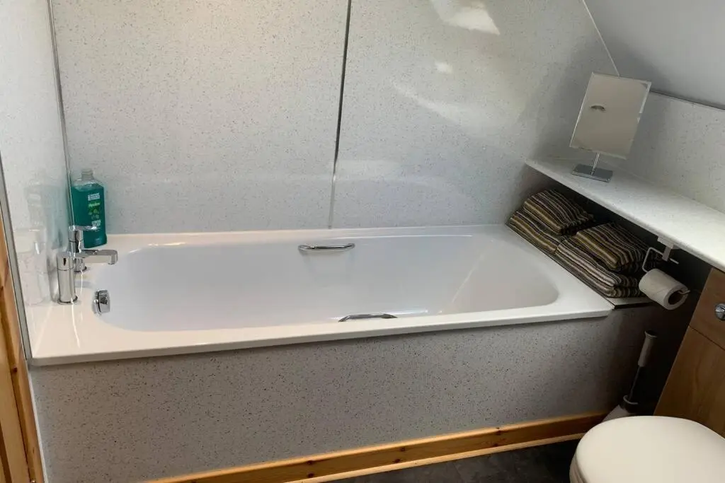 a white bath tub in a bathroom with a toilet at The Nest - Near Inverness & Loch Ness in Inverness