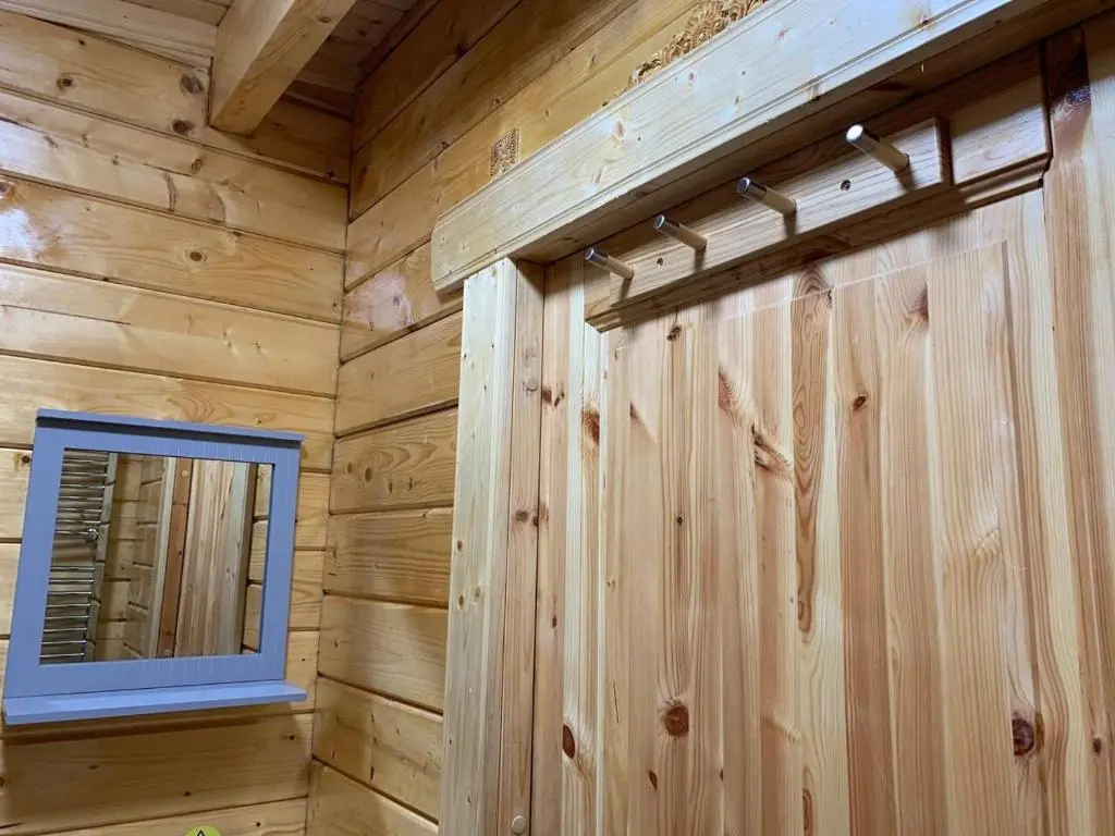 a log cabin with a mirror and a window at Immaculate Cabin 5 mins to Inverness Dog friendly in Inverness