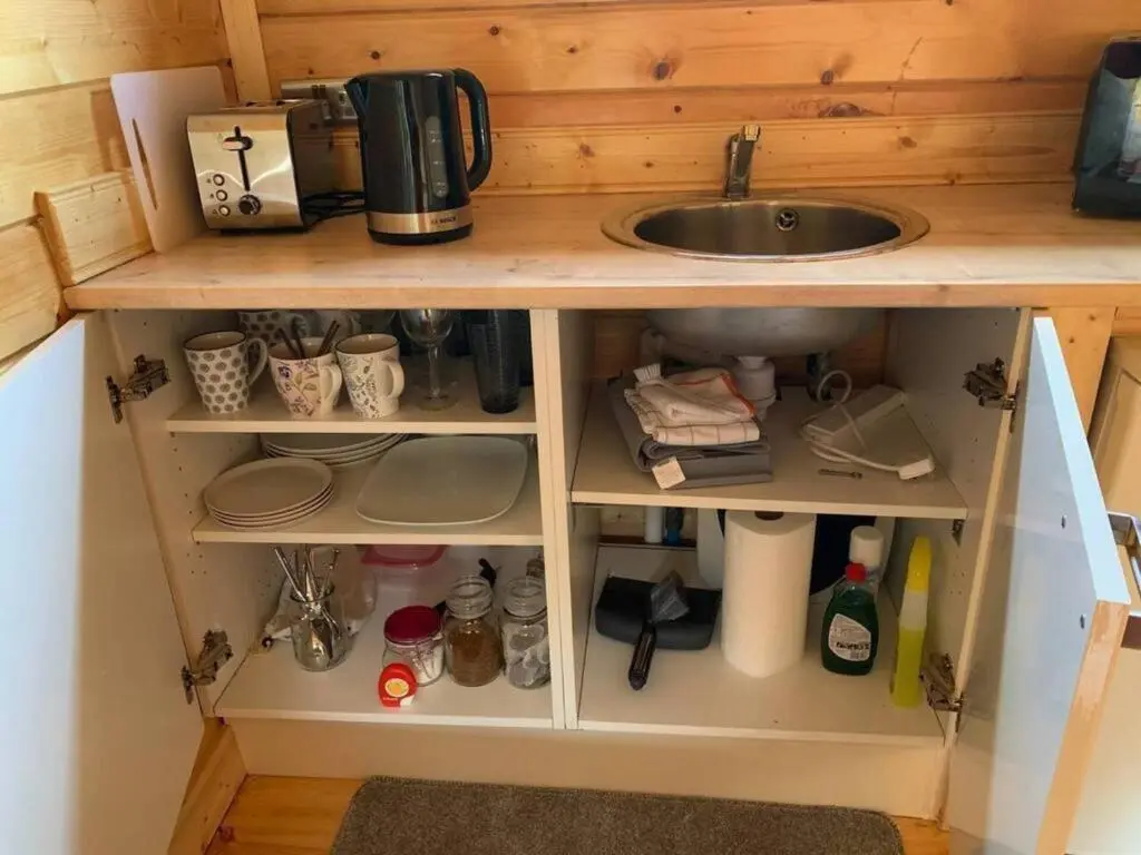 a kitchen cabinet with a sink and a counter top at Immaculate cabin 5 mins to Inverness dogs welcome in Inverness