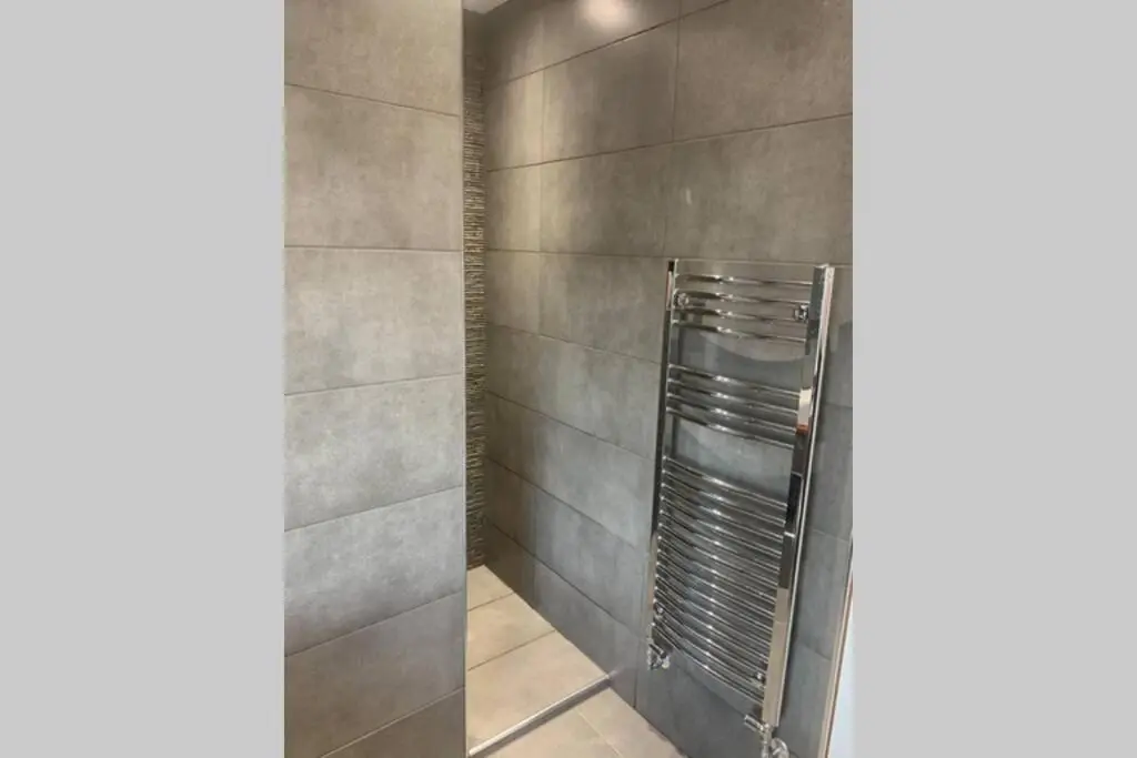 a shower with a metal ladder in a bathroom at In the heart of Inverness in Inverness