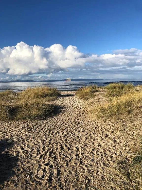 a sandy beach with the ocean in the background at Willowbarn Rafford Self Catering in Forres