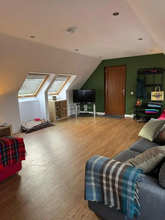 a living room with a couch and a flat screen tv at Willowbarn Rafford Self Catering in Forres