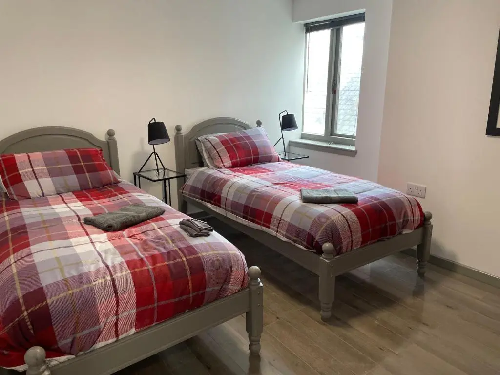 two beds sitting next to each other in a bedroom at Rooms in Inverness in Inverness