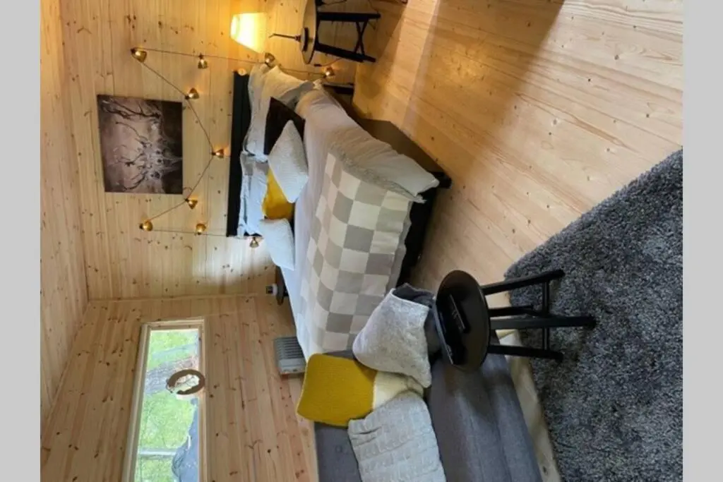 an overhead view of a couch in a tiny house at Coorie Doon Cabin! Great Scottish Welcome in Fort Augustus
