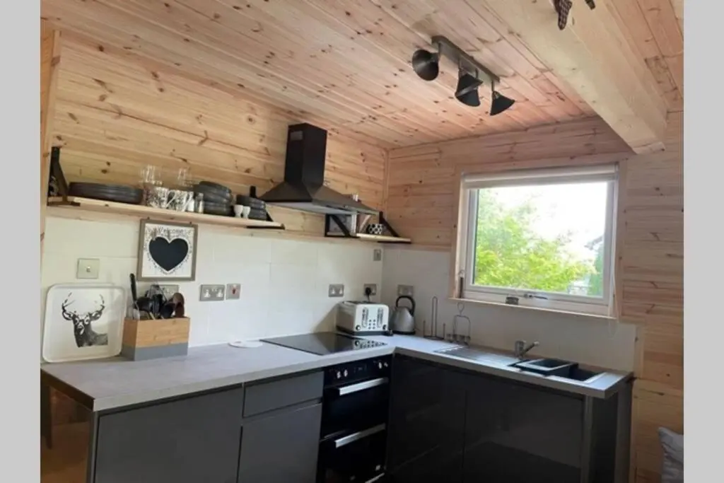 a kitchen with a counter top and a window at Coorie Doon Cabin! Great Scottish Welcome in Fort Augustus