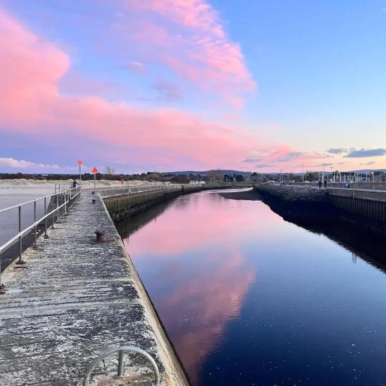 a view of a body of water with a pier at Seaview House - A Traditional Home by the Beach in Nairn