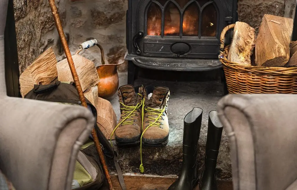 a group of boots sitting in front of a fireplace at The Boat Inn in Aboyne