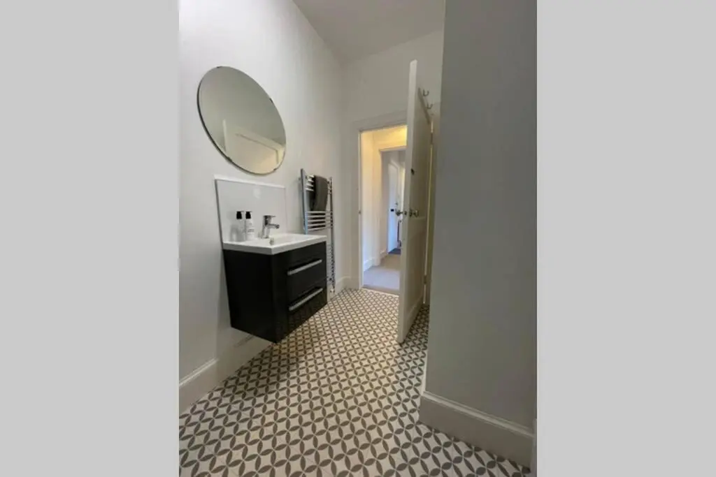 a bathroom with a sink and a mirror at No 10 Immaculate City Centre, Top Floor 2 Bed Flat with Free Parking in Inverness