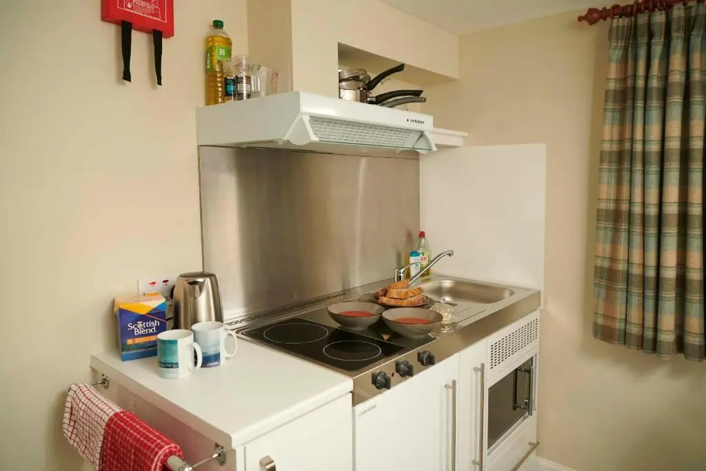 a kitchen with a stove with two bowls on it at Downright Gabbler in Beauly