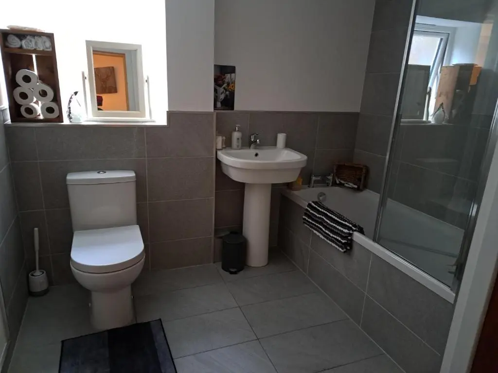 a bathroom with a toilet and a sink and a shower at The Apartment in Aberlour in Aberlour