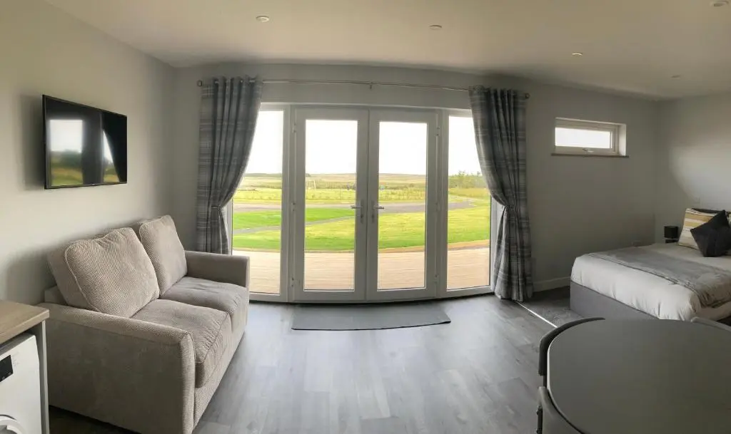 a living room with a couch and a bed at North Coast Escapes in Thrumster