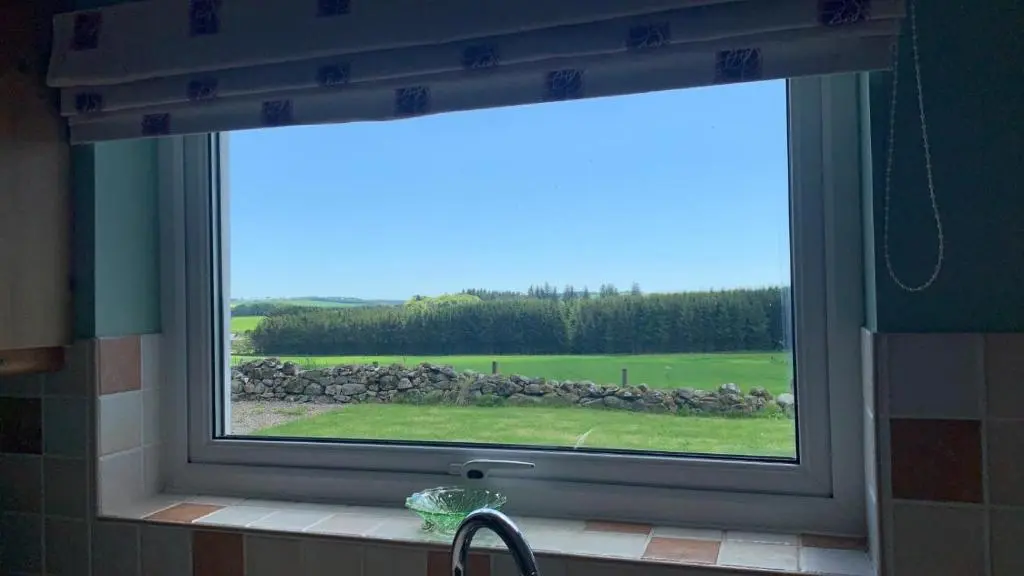 a window in a bathroom with a view of a field at Meikle Aucheoch Holiday Cottage, plus Hot Tub, Near Maud, in the heart of Aberdeenshire in Peterhead