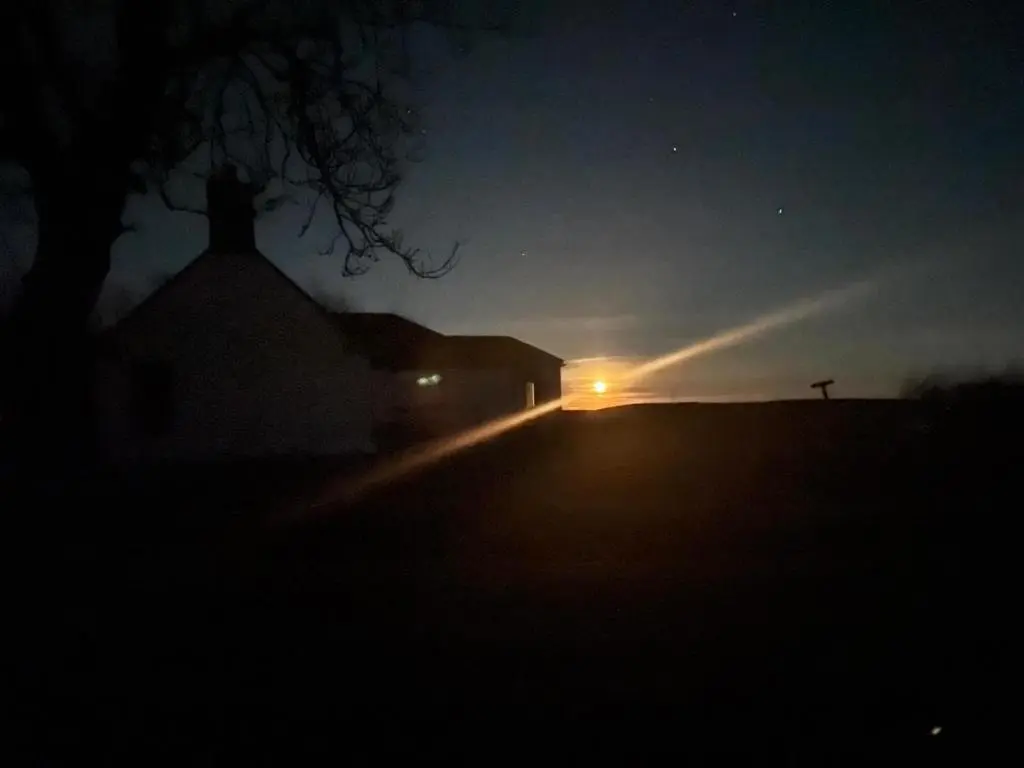 a church at night with the light shining on a street at Meikle Aucheoch Holiday Cottage, plus Hot Tub, Near Maud, in the heart of Aberdeenshire in Peterhead