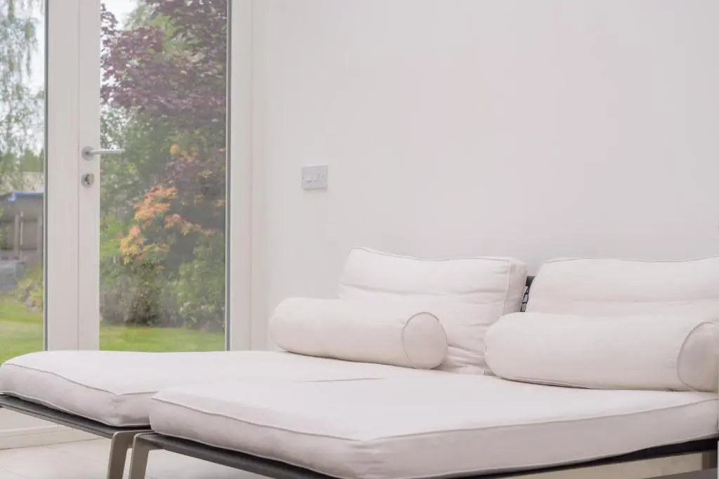 a white couch sitting in front of a window at Haven Retreat Scotland - Large 4 Bed House with Woodland garden, Aboyne ,Royal Deeside in Aboyne