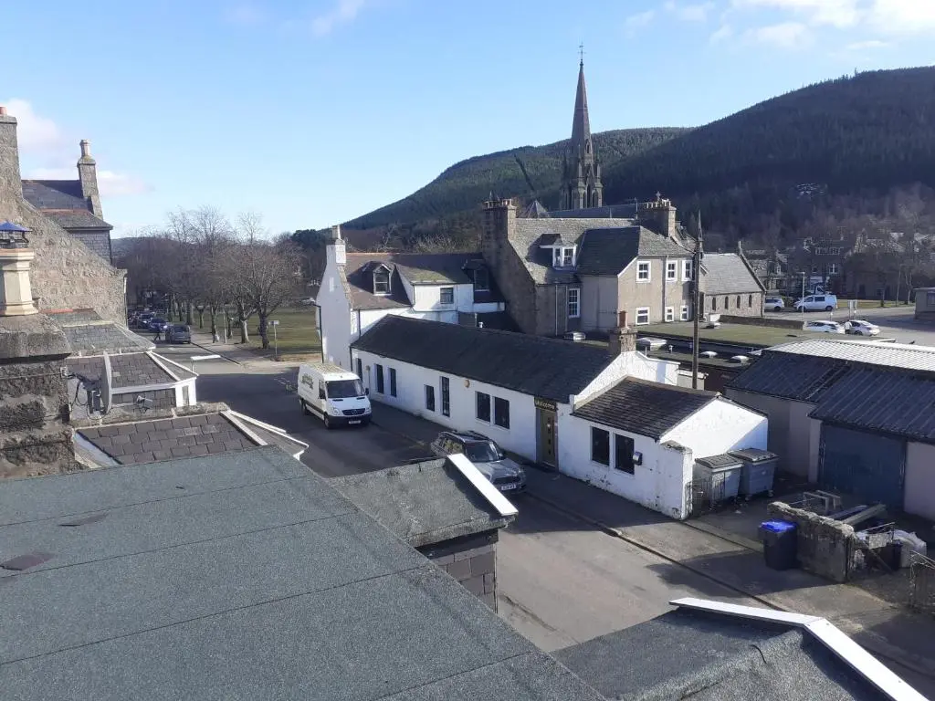 an aerial view of a small town with a church at Just off the Square... Ballater in Ballater