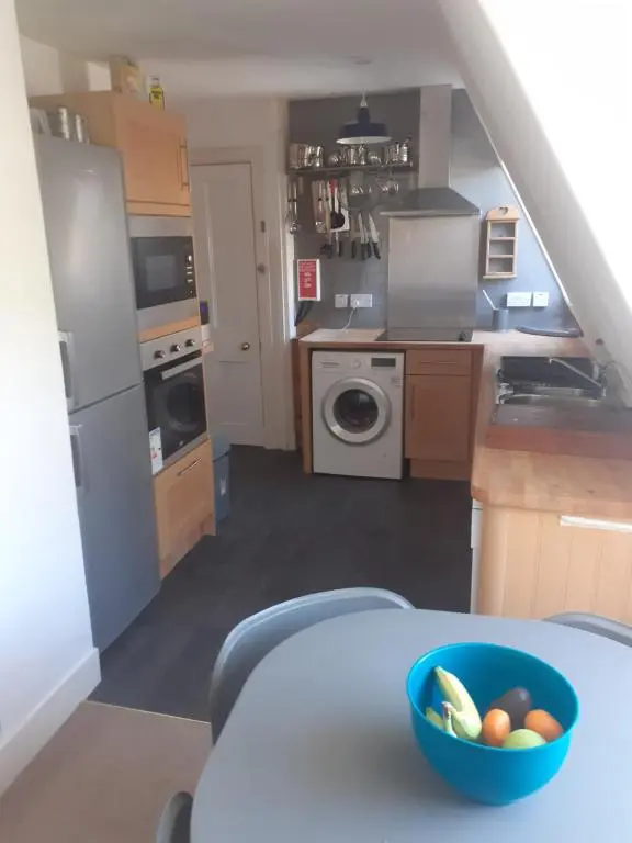 a kitchen with a bowl of fruit on a table at Just off the Square... Ballater in Ballater